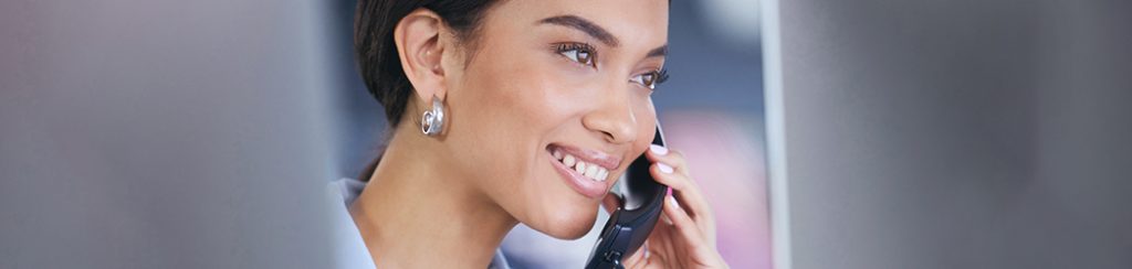 Woman using a business VOIP phone soltuion with cloud communication