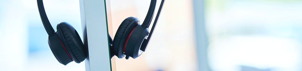 VOIP Phone headset hanging on a monitor